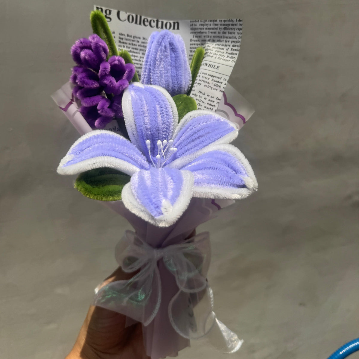 Floral arrangement with purple and white flowers on a gray background